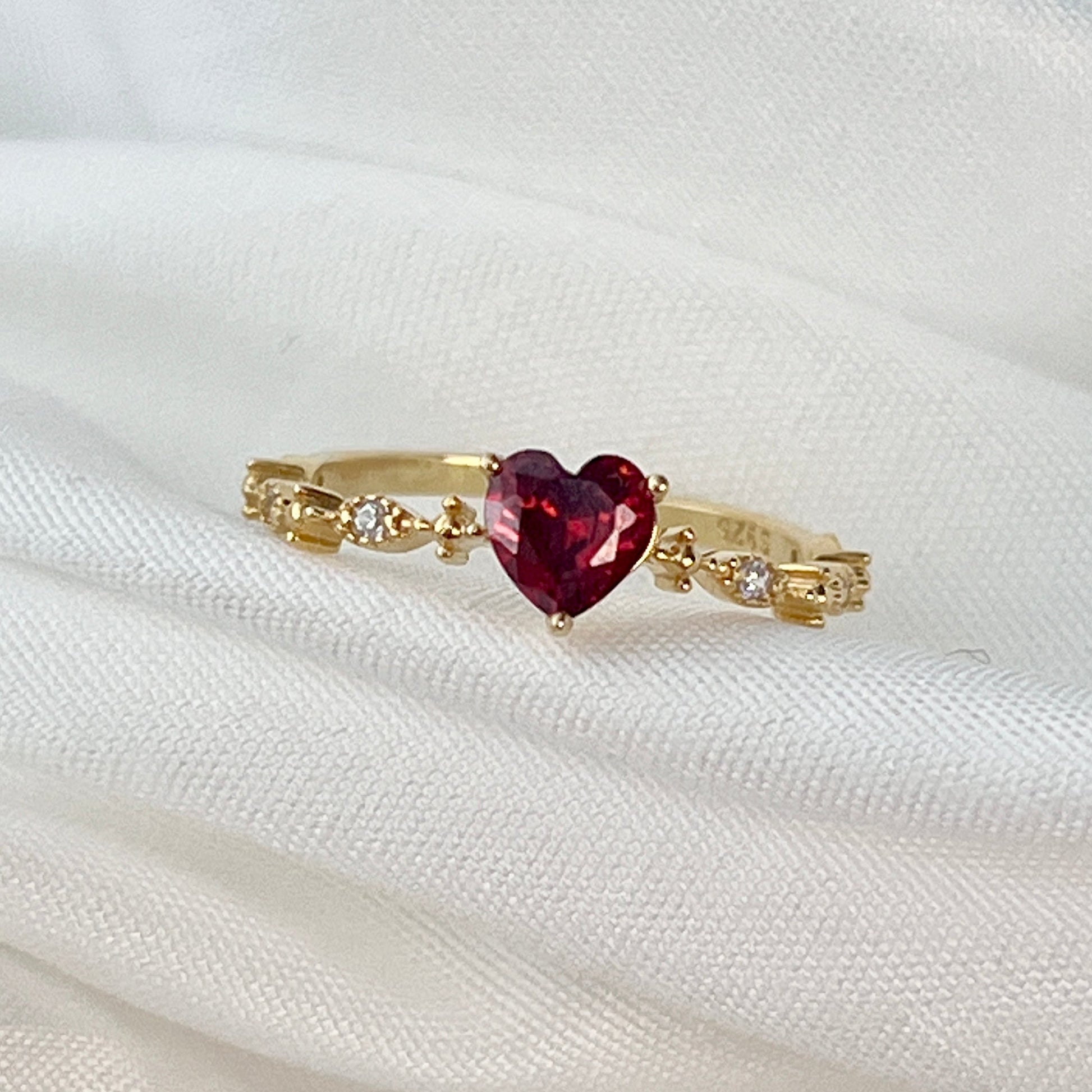 The Red Heart Diamond Gold Ring is a captivating symbol of love and passion. Crafted in luxurious gold, this stunning ring features a striking red heart-shaped diamond at its center, radiating warmth and elegance. The diamond's vivid color is complemented by the gleam of the gold band, creating a perfect blend of romantic charm and timeless beauty. Whether it's a gift for a loved one or a meaningful personal treasure, this ring is designed to make a statement of love, passion, and enduring commitment.